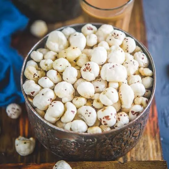 White puffed makhana fox nuts spilling from a linen pouch